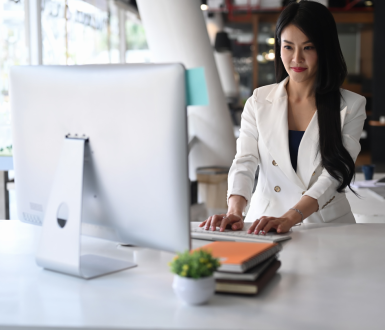 Woman on a Computer Looking at MBA Essay Guiding Principles